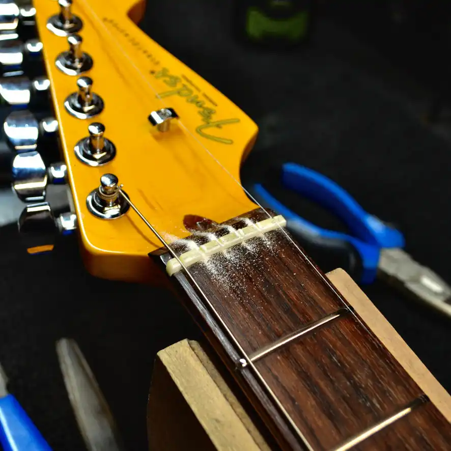 Fender Professional II Stratocaster: The new nut rough cut and in place, halfway through slot cutting.